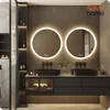 A modern bathroom vanity with two round LED mirrors, black sinks, and dark cabinetry. Náhled obrázku produktu
