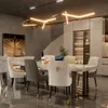 A modern dining room with a marble table and chairs, illuminated by a unique chandelier. Podgląd zdjęcia produktu