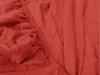 A close-up view of a red fitted bed sheet, showing the elasticized edge and fabric texture. Produktbild-Vorschau