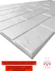 A close-up, angled view of a white 3D polystyrene wall panel with a brick-like texture. Náhled obrázku produktu