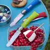 A close-up of Opinel knives and red currants on a blue table. Podgląd zdjęcia produktu