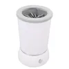 A white automatic pet paw cleaner with a gray rim and interior brushes, shown against a white background. Voir les images du produit