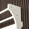 A close-up view of a white wooden climbing frame against a dark, ribbed background. Voir les images du produit