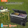 A portable dual-zone cooler is set up outdoors on the grass next to a folding table with a camping stove and a bottle of beer. Náhled obrázku produktu