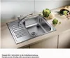 A stainless steel kitchen sink with a faucet and a draining board, placed on a countertop with some vegetables. Náhľad obrázku produktu