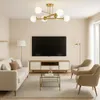 A modern living room with a sofa, coffee table, TV, and a ceiling light. Náhľad obrázku produktu