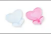 Two heart-shaped pacifiers, one blue and one pink, are shown against a white background. Produktbild-Vorschau