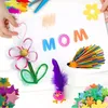 A child's hands are shown creating a craft project on a white surface, with various craft supplies scattered around. Produktbild-Vorschau