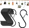 A collection of black S-hooks hanging on a wooden rod, with various decorative hanging items above them. Produktbild-Vorschau