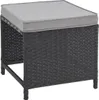 A black rattan ottoman with a gray cushion on a white background. Produktbild-Vorschau