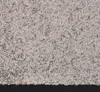 A close-up view of a gray carpet or rug. Voir les images du produit