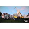 Construction vehicles on a construction site with buildings in the background. Produktbild-Vorschau