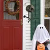 A Halloween-themed porch decoration with a skull-shaped wall hanger and a child dressed as a ghost holding a pumpkin. Produktbild-Vorschau