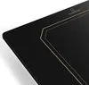 A close-up view of a black induction hob with gold decorative lines and the brand logo. Podgląd zdjęcia produktu