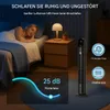 A woman sleeping in bed next to a nightstand with a lamp, while a tower fan stands nearby. Anteprima dell’immagine prodotto