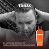 A man showering with a bottle of Tabac Original shower gel. Podgląd zdjęcia produktu