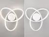 A split image showing a white LED ceiling light with a tri-ring design. The left side shows the light illuminated, while the right side shows it unlit against a gray background. Podgląd zdjęcia produktu