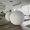 A yoga studio with mirrors, yoga mats, and large spherical objects. Produktbild-Vorschau
