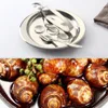 A set of stainless steel snail dishes with tongs and a fork, shown above a close-up of cooked snails. Produktbild-Vorschau