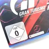 A close-up of the Gran Turismo 7 game packaging, showing the USK rating and game title. Produktbild-Vorschau