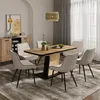 A dining room scene with a table and chairs, a sideboard, and a painting on the wall. Anteprima dell’immagine prodotto
