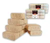 A stack of wood briquettes in the foreground and two packages of wood briquettes in the background. Anteprima dell’immagine prodotto