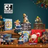 A collection of pop culture themed advent calendars and figures arranged on a wooden surface with a Christmas tree and lights in the background. Podgląd zdjęcia produktu