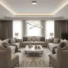 A luxurious living room with multiple sofas, a coffee table, and a large rug, illuminated by a modern chandelier. Anteprima dell’immagine prodotto