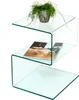 A clear glass side table with a plant and magazines. Voir les images du produit
