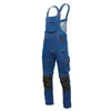 A pair of blue denim overalls with black knee patches and cargo pockets, shown against a white background. Náhled obrázku produktu