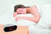 A woman sleeping in bed next to an alarm clock. Náhled obrázku produktu