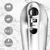 A close-up of a silver hand mixer with control buttons on a marble background. Produktbild-Vorschau