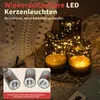 Three LED candles with fairy lights inside glass holders, placed on a decorative cloth. Produktbild-Vorschau
