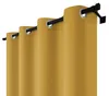 A close-up view of yellow curtains hanging on a black curtain rod. Náhled obrázku produktu