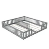 A grey wooden bed frame with two mattress bases and safety rails, shown from a diagonal angle against a white background. Produktbild-Vorschau