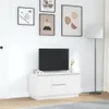 A white TV stand with a black TV on top, displayed in a room with artwork on the wall and a floor lamp. Náhľad obrázku produktu