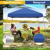A woman sits under a blue canopy tent by a lake, with a table and chairs set up. Produktbild-Vorschau