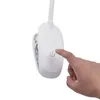 A hand is pressing the power button on a white clip-on LED lamp. Produktbild-Vorschau