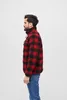 A man wearing a red and black plaid jacket and blue jeans, shown from the side against a white background. Produktbild-Vorschau