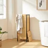 A laundry basket in a bathroom setting next to a bathtub. Podgląd zdjęcia produktu