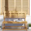 A wooden garden bench is placed on a patio in front of a window with slatted shutters. A cup of coffee and a stack of books with headphones are on the bench. Produktbild-Vorschau