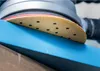 A close-up of a sanding pad on a blue surface. Náhľad obrázku produktu