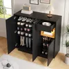 A black shoe cabinet with multiple shelves and a drawer, filled with shoes and accessories, placed in a room with a window and a lamp. Podgląd zdjęcia produktu