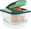 A close-up studio shot of a food chopper with a piece of red food being chopped. Produktbild-Vorschau
