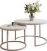 A set of two nesting coffee tables with a marble-like top and metal legs, decorated with a vase of flowers and a book. Náhľad obrázku produktu