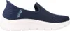 A side view of a navy blue Skechers slip-on sneaker with a white sole. Produktbild-Vorschau