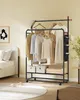 A clothing rack with clothes and accessories in a bedroom setting. Produktbild-Vorschau