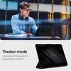 A person using a tablet in a modern setting, with a close-up of the tablet in theater mode. Podgląd zdjęcia produktu