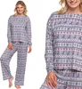 A woman modeling a grey pajama set with a Nordic-inspired reindeer pattern. Produktbild-Vorschau