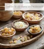 Several small wooden bowls filled with different types of incense resins are arranged on a wooden tray. Produktbild-Vorschau